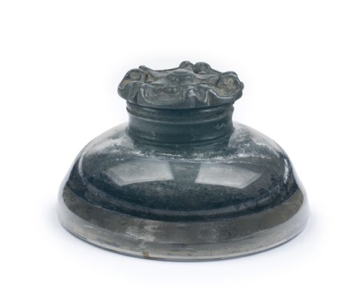 Dark glass inkwell used during the signing of the Emancipation Proclamation, with a wide rounded base and decorative rim.