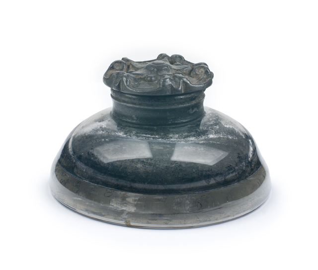 Dark glass inkwell used during the signing of the Emancipation Proclamation, with a wide rounded base and decorative rim.